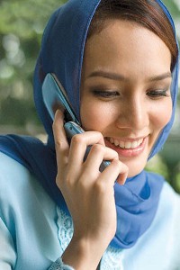 Malaysian Muslim woman using cell phone